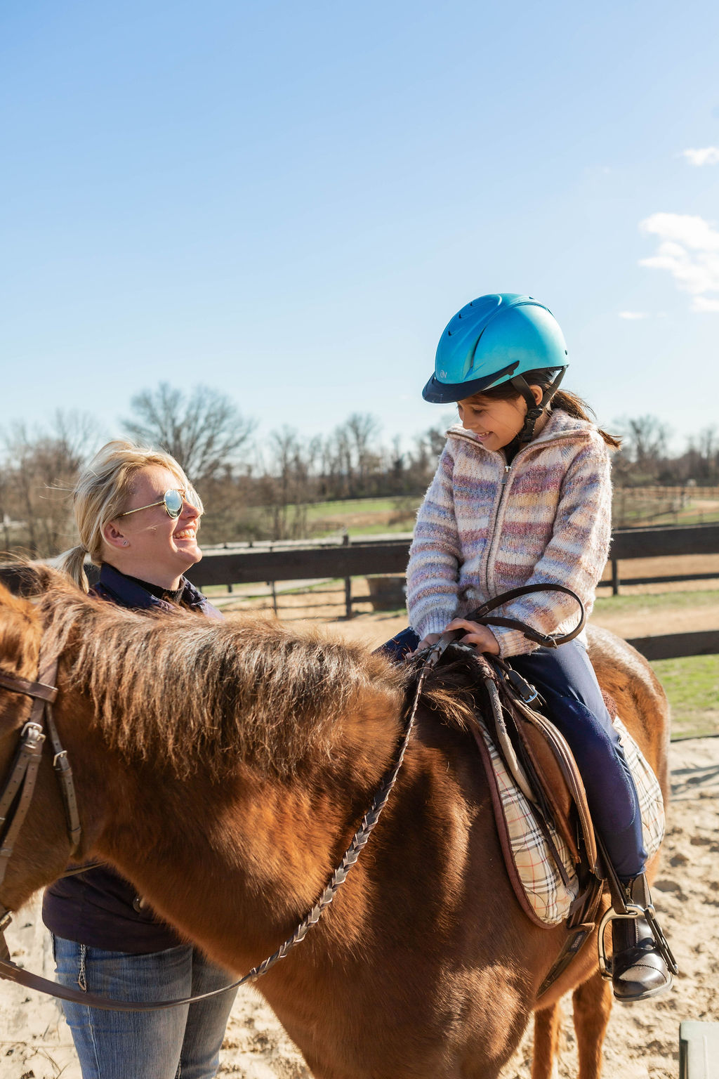 Olivia teaching a young student during a riding lesson